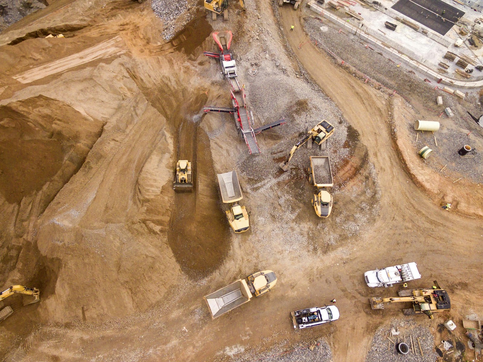 Aerial view of a JD Contractors groundworks site with excavators, dumpers and drainage works